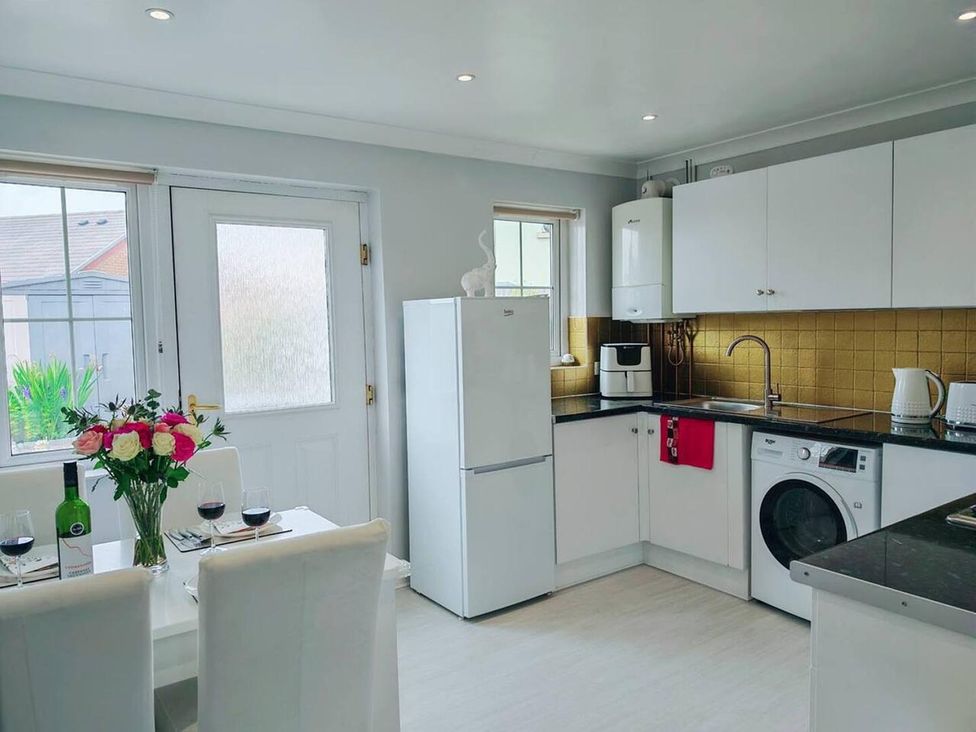 A kitchen with a dining table and flowers at a residential property in 