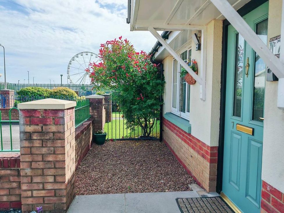 An outdoor area with a door and plants at the property