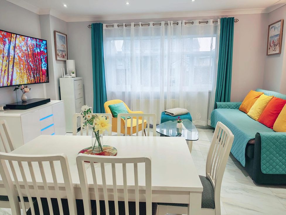 A living room with a dining area and television at 