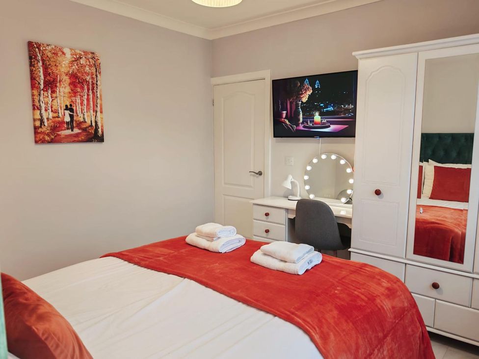 A bedroom with a bed and television at The Old Barn in Manchester