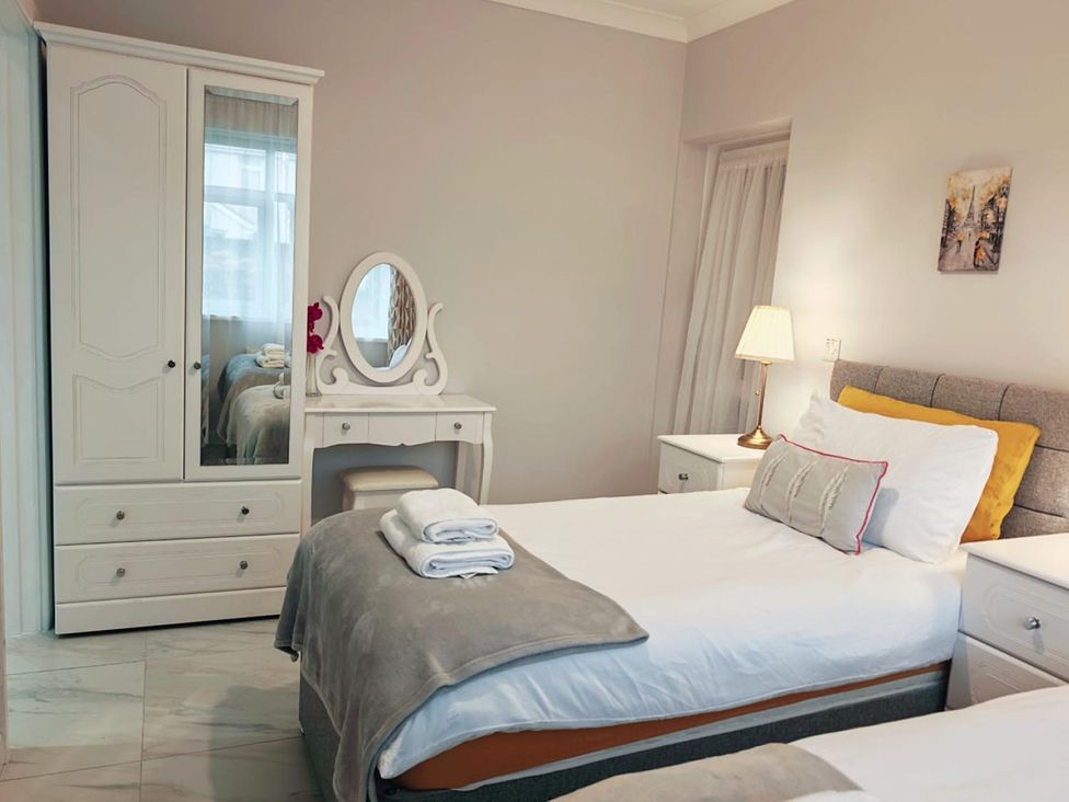 A bedroom with two beds and a wardrobe at the property location