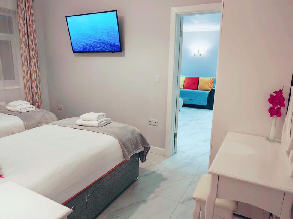 A bedroom with two beds and a television at 