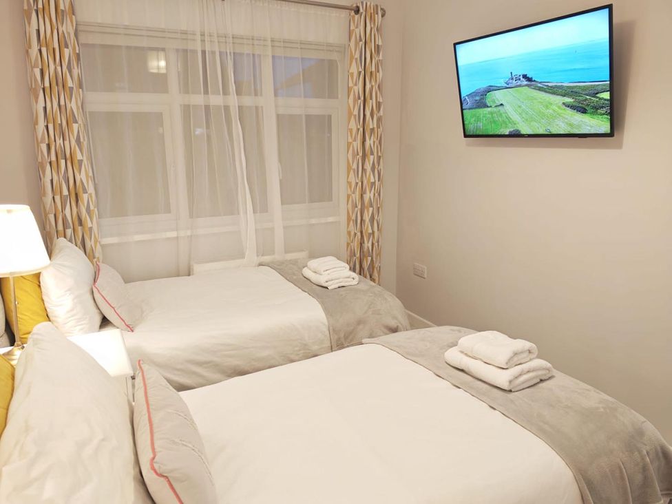 A bedroom with two beds and a television at the property location