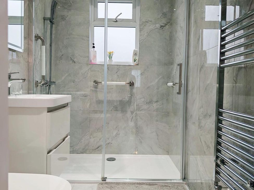 A bathroom with a shower and sink at The Old Barn in Manchester
