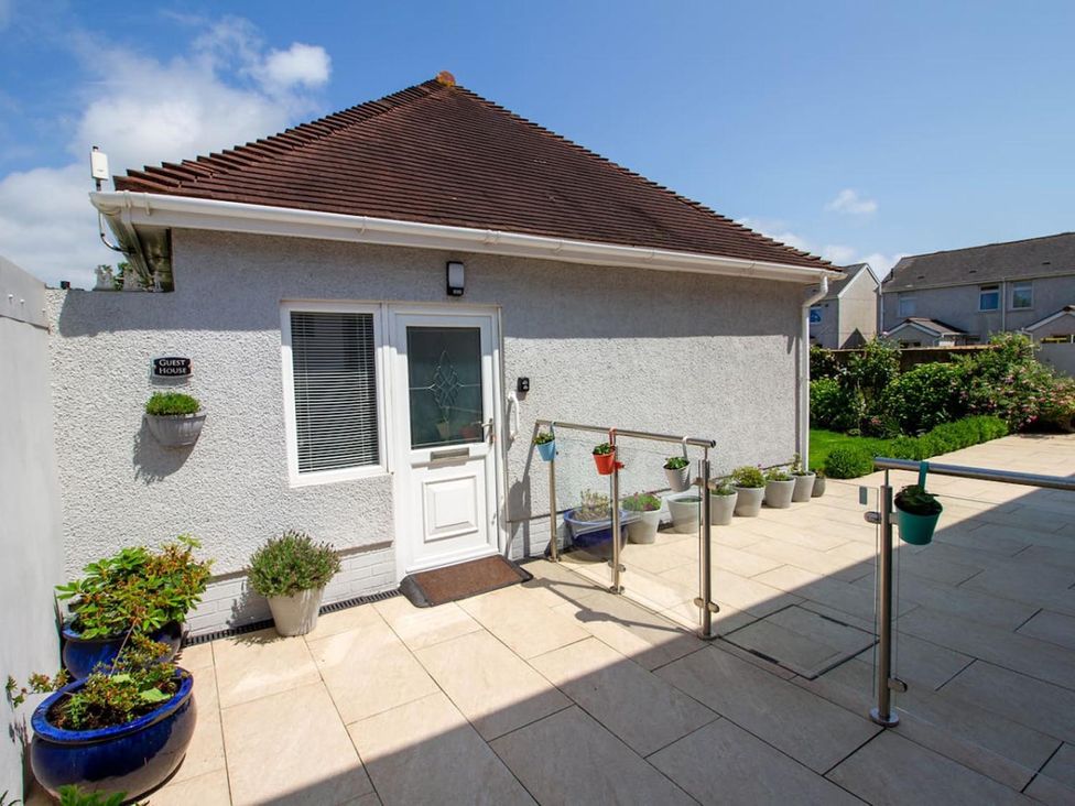 An entrance with a door and plant pots at a guest house