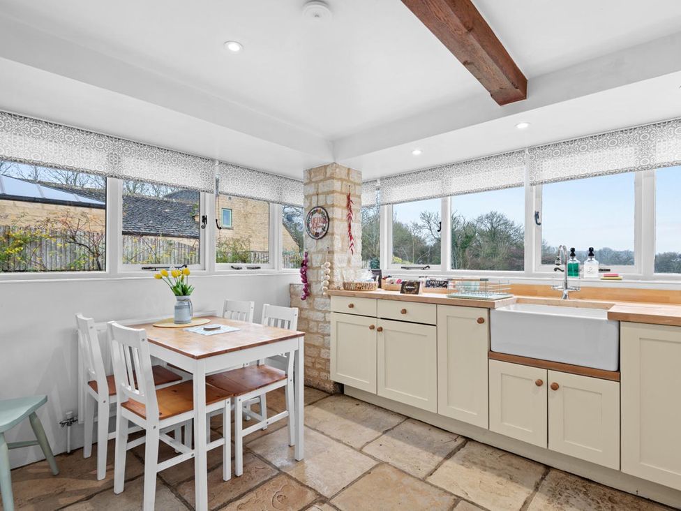 A kitchen with a dining area and a sink at The Old Barn in Manchester