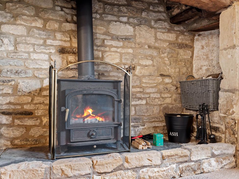 A wood burning stove with accessories at a cottage