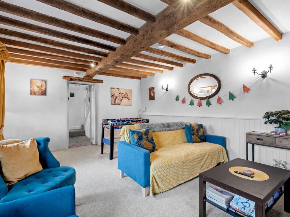A snug with a foosball table and couches at The Old Barn in Manchester
