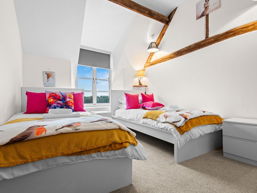 A bedroom with two beds and a window at the property