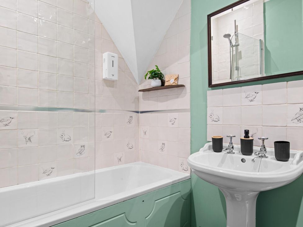 A bathroom with a bathtub and sink at The Old Barn in Manchester