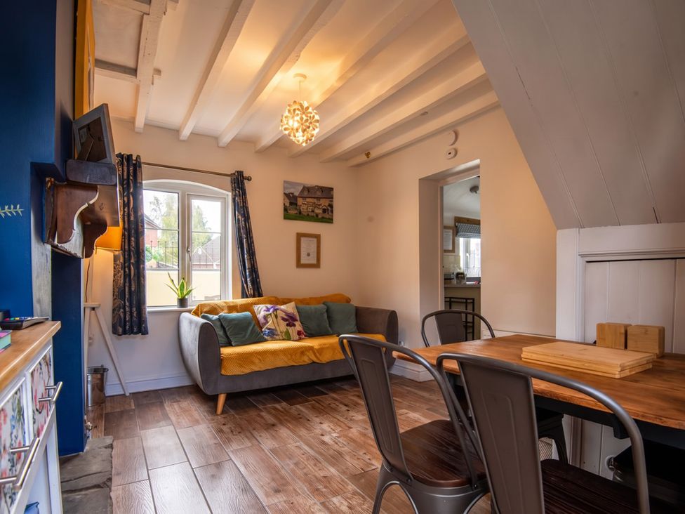 A living room with a sofa and dining table at The Old Barn in Manchester