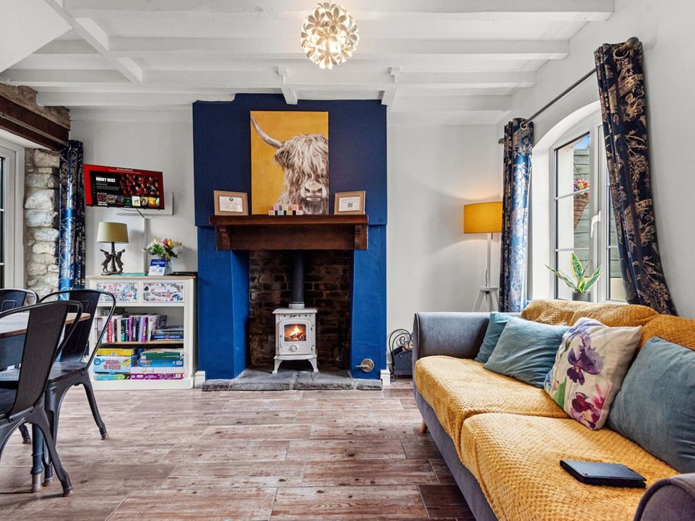 A living room with a fireplace and sofa at The Old Barn in Manchester