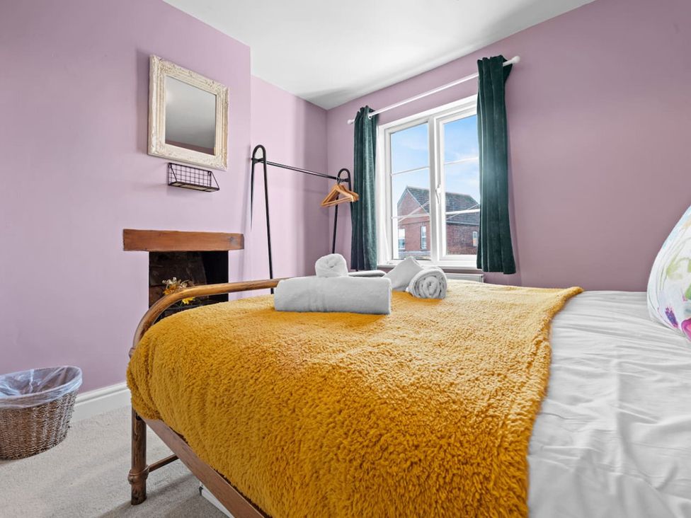 A bedroom with a bed and towels on top at The Old Barn in Manchester