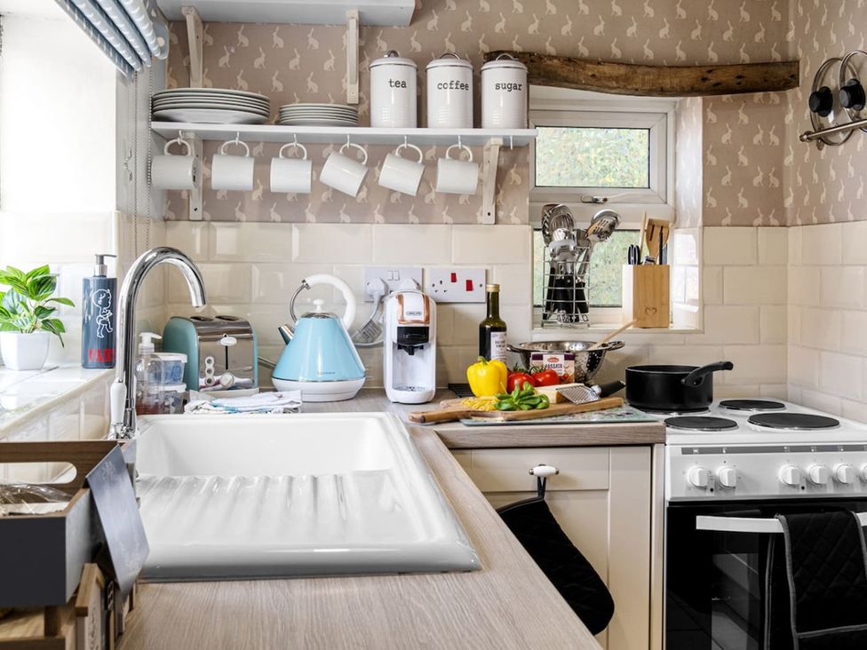 A kitchen with various appliances and utensils at 