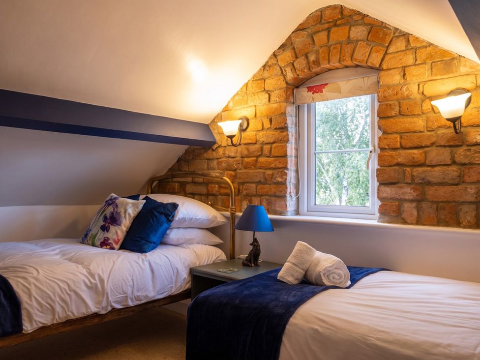 A bedroom with two beds and a window at the property