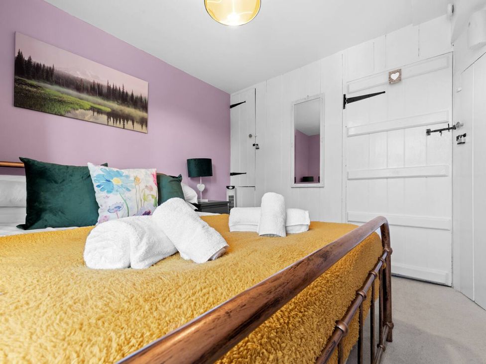 A bedroom with a bed and wall art at The Old Barn in Manchester