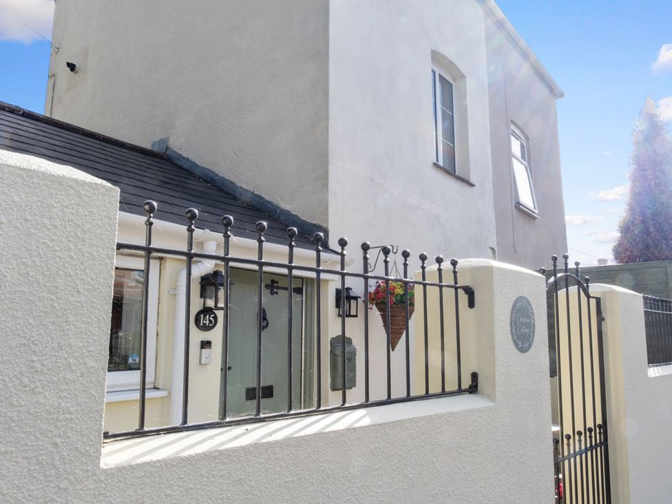 A house exterior with a gate and number 145 at The House in Unknown location