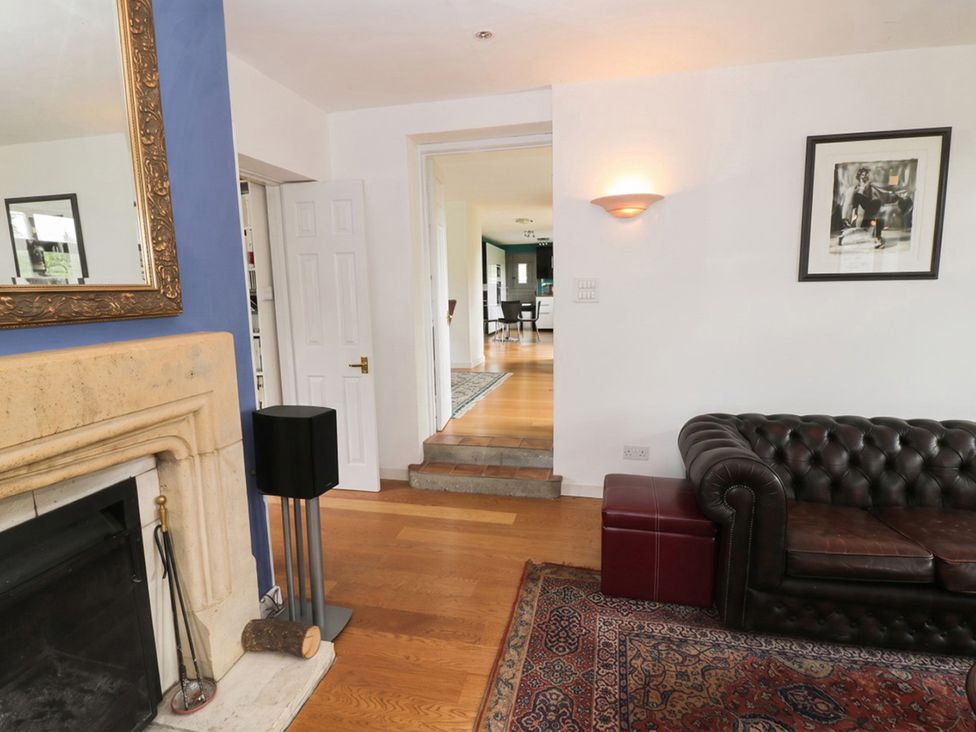 A living room with a fireplace and sofa at The Old Barn in Manchester