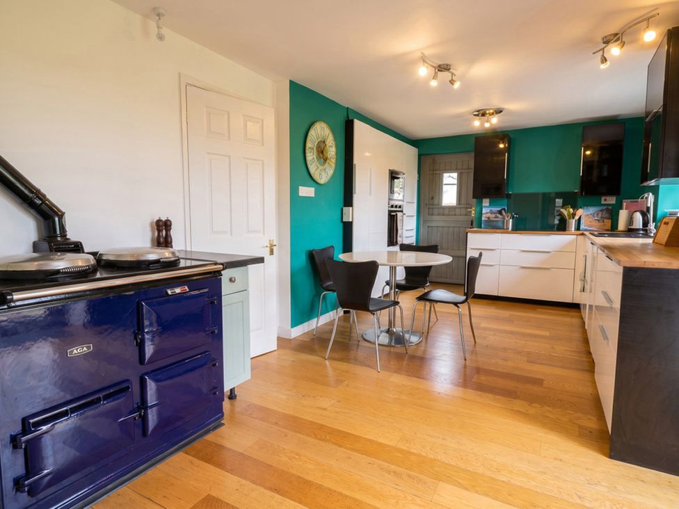 A kitchen with an AGA stove and a dining table at the property in the location