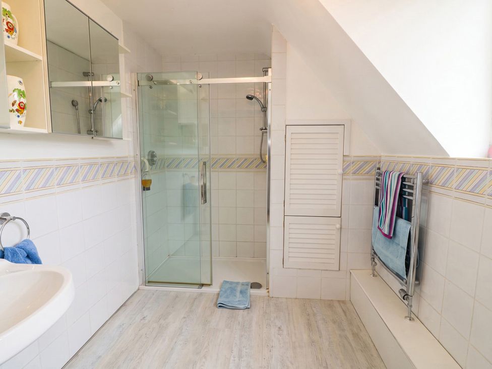 A bathroom with shower and sink at the property in the location