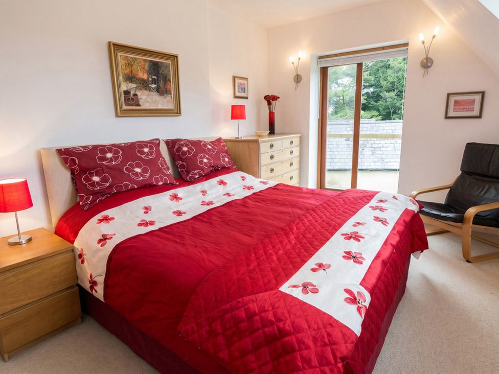 A bedroom with a bed and a window at a property