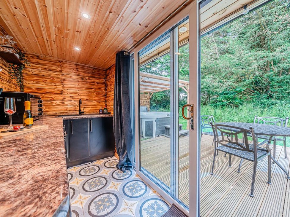 A kitchen area with a sliding glass door leading to a deck at the property