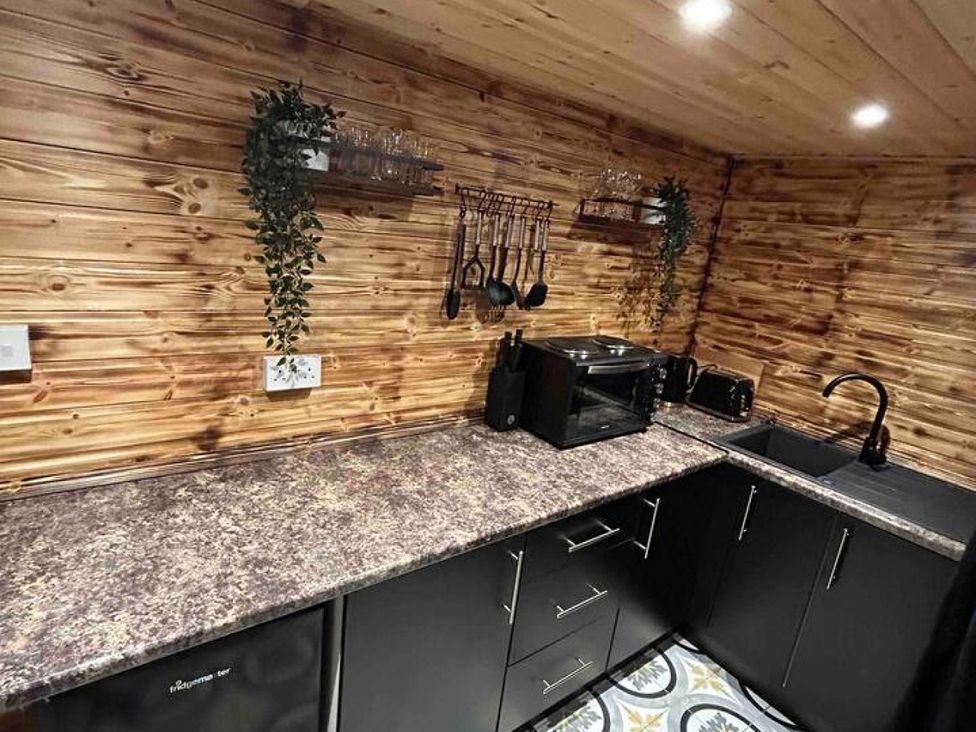 A kitchen with a countertop and utensils at 