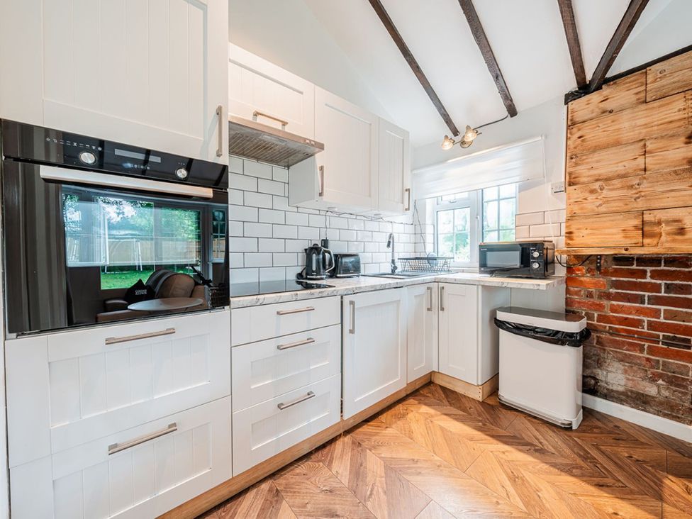 A kitchen with cabinets and appliances at the property