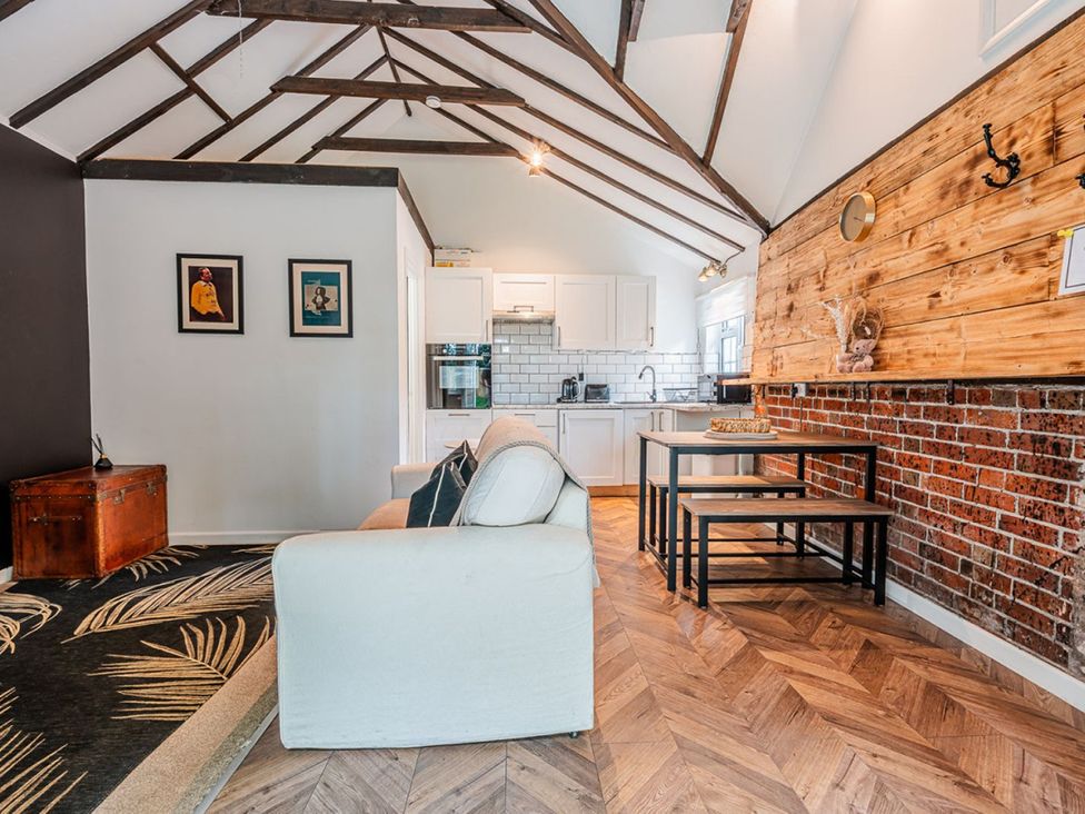 A living room with sofa and dining table at the property