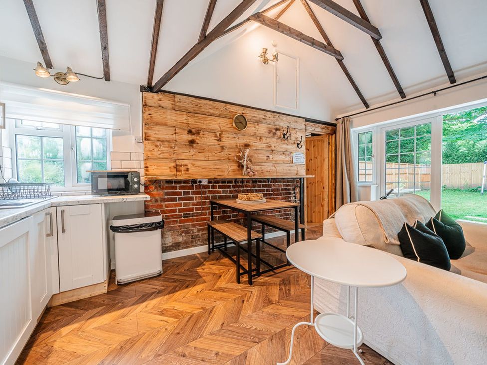 A kitchen with a table and chairs at The Old Barn in Manchester