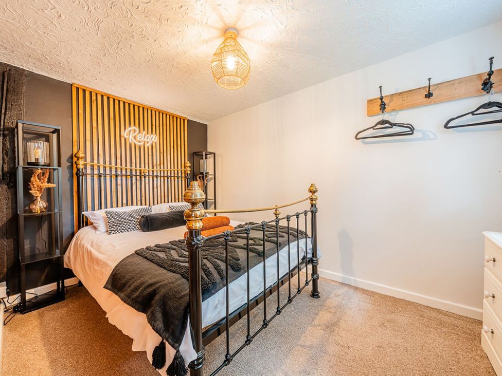 A bedroom with a bed and decorative items at The Old Barn in Manchester
