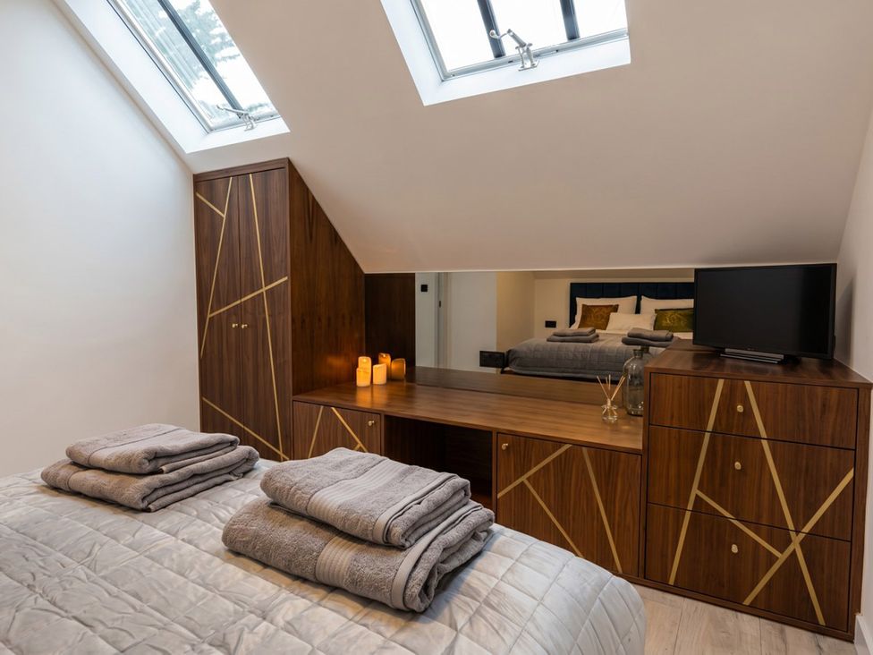A bedroom with a bed and dresser at Emery Street Lodge