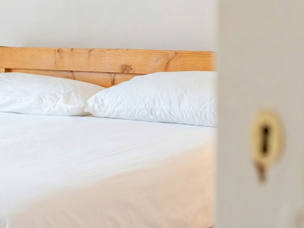 A bed with pillows in a bedroom at Furzen Farmhouse