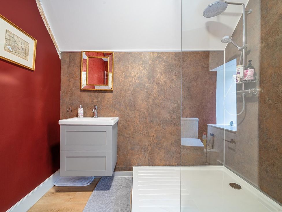 A bathroom with a sink and shower at Furzen Farmhouse