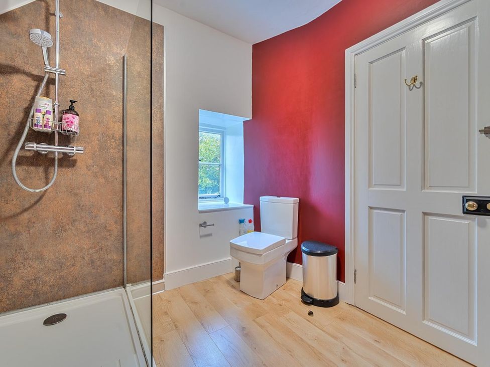 A bathroom with a shower and toilet at Furzen Farmhouse