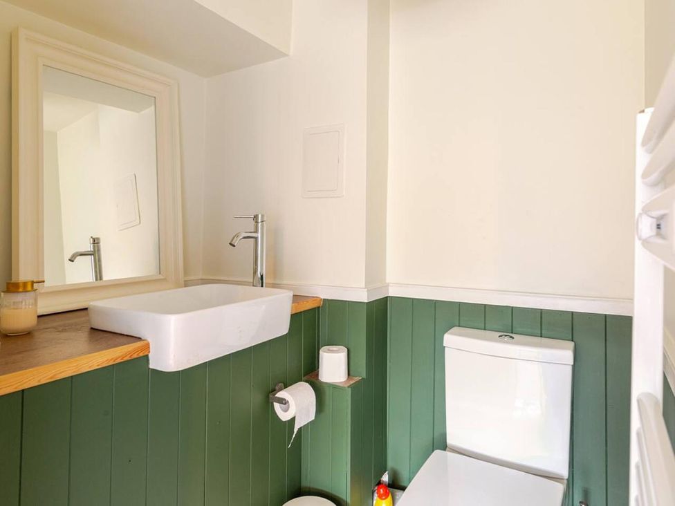 A bathroom with a sink and toilet at Furzen Farmhouse