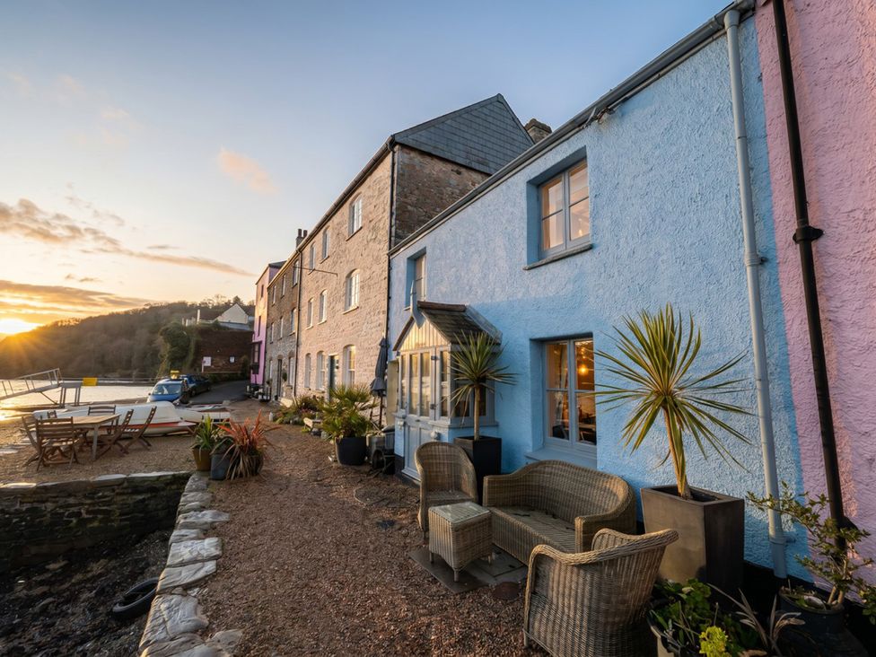 An outdoor seating area next to a house at Quay Cottage in 