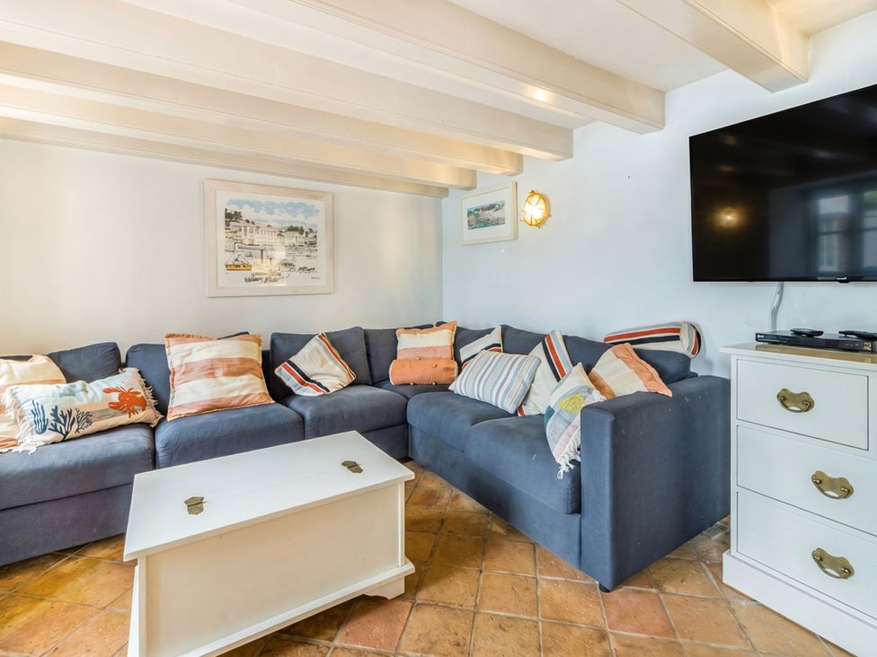 A living room with a sofa and coffee table at Quay Cottage
