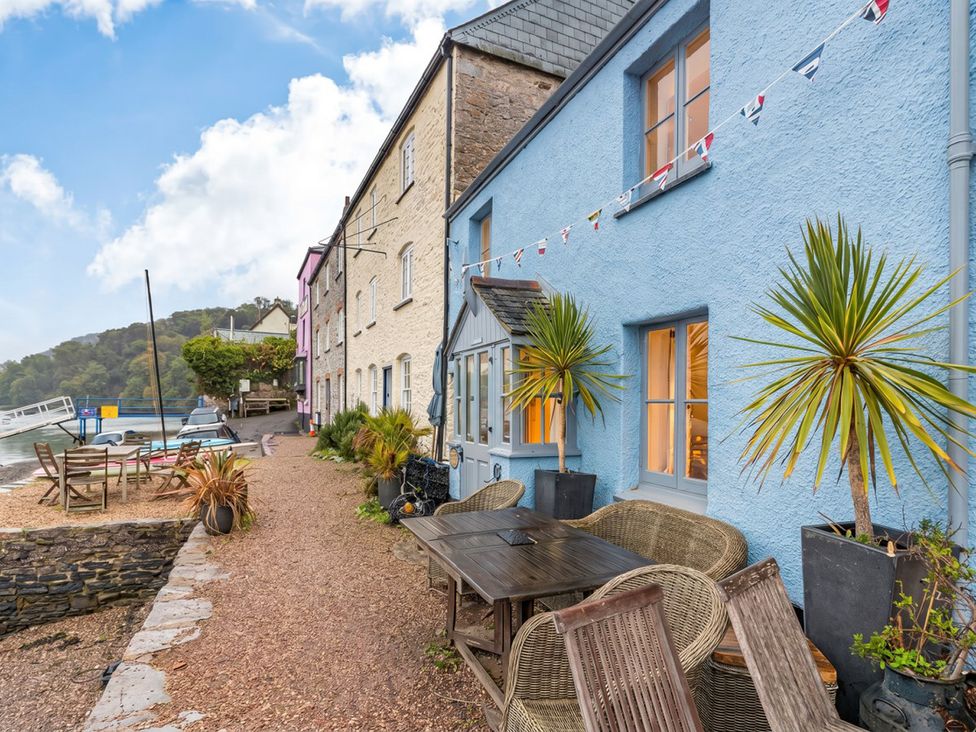 An outdoor area with tables and chairs at Quay Cottage