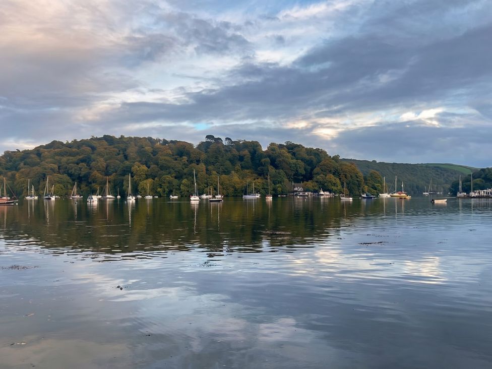 A view of boats on water with trees and hills in the background at Quay Cottage