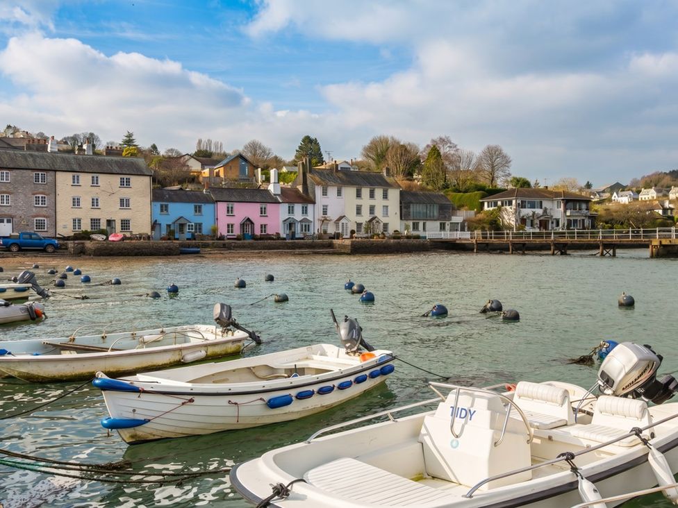 A view of boats in the water beside houses at Quay Cottage in 