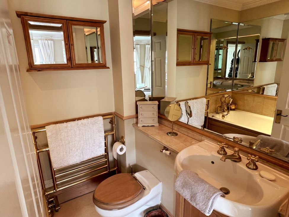 A bathroom with a sink and mirror at Circus Mews Townhouse