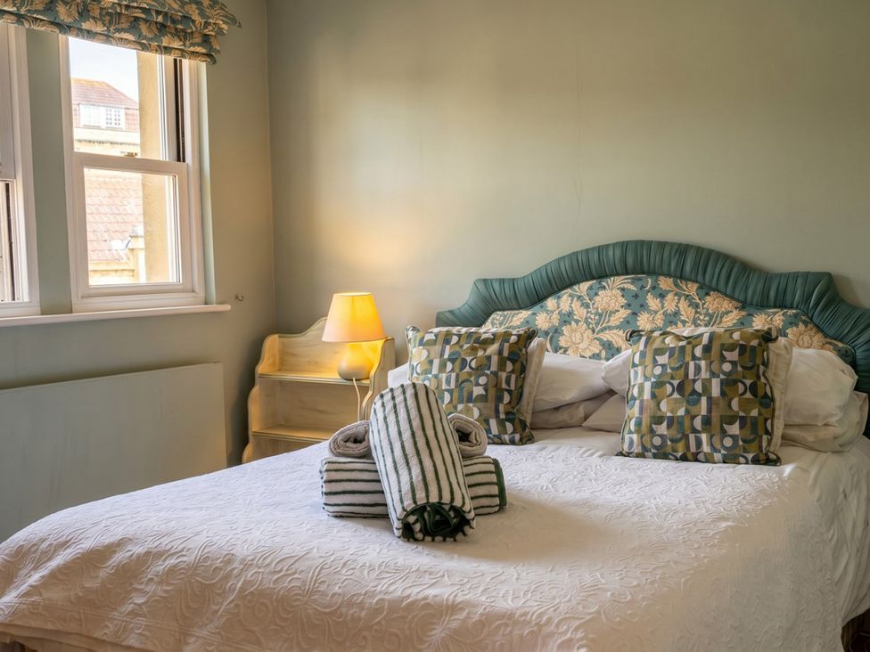 A bedroom with a bed and pillows at Circus Mews Townhouse