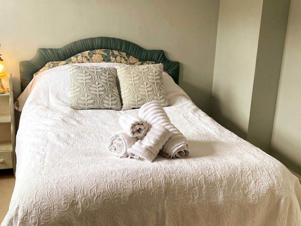 A bedroom with a bed and pillows at Circus Mews Townhouse