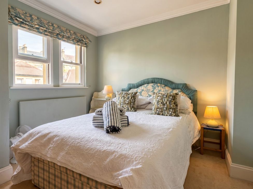 A bedroom with a bed and pillows at Circus Mews Townhouse