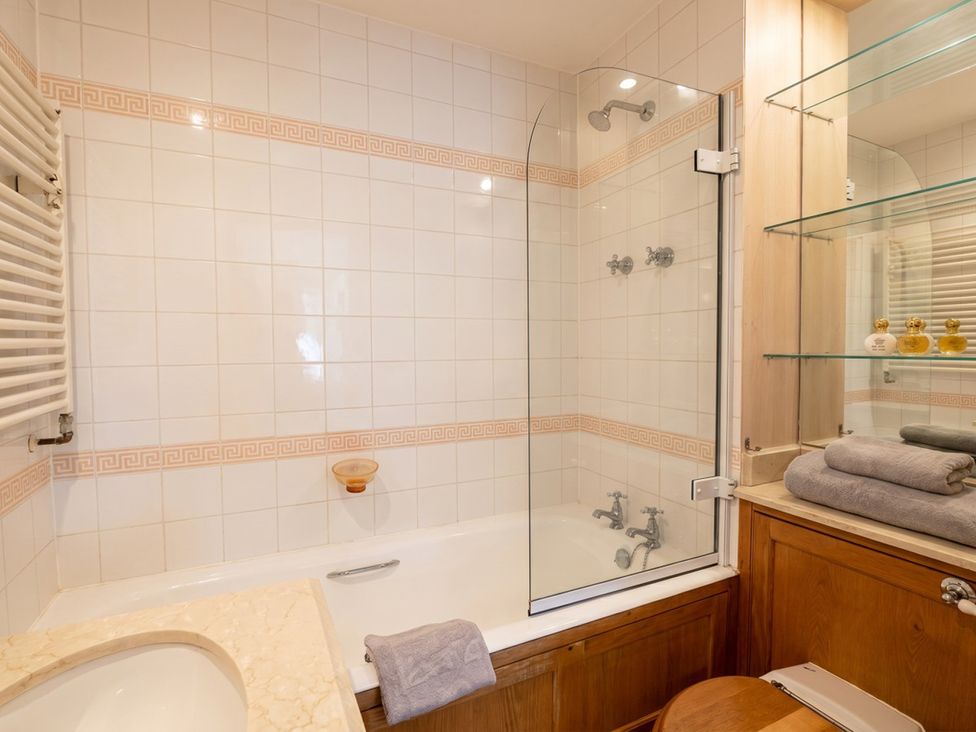 A bathroom with a shower and bathtub at Circus Mews Townhouse