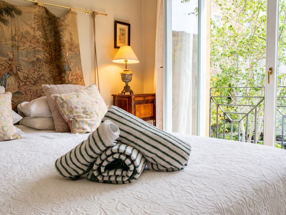 A bedroom with pillows and towels arranged on a bed at Circus Mews Townhouse