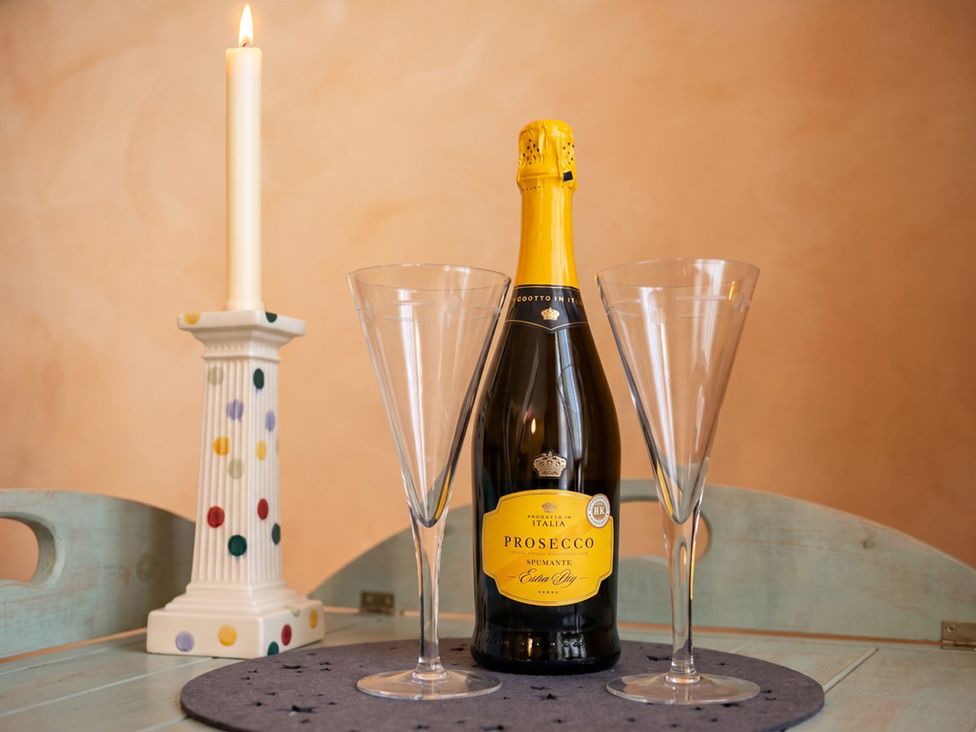 A champagne bottle and glasses on a table at Circus Mews Townhouse