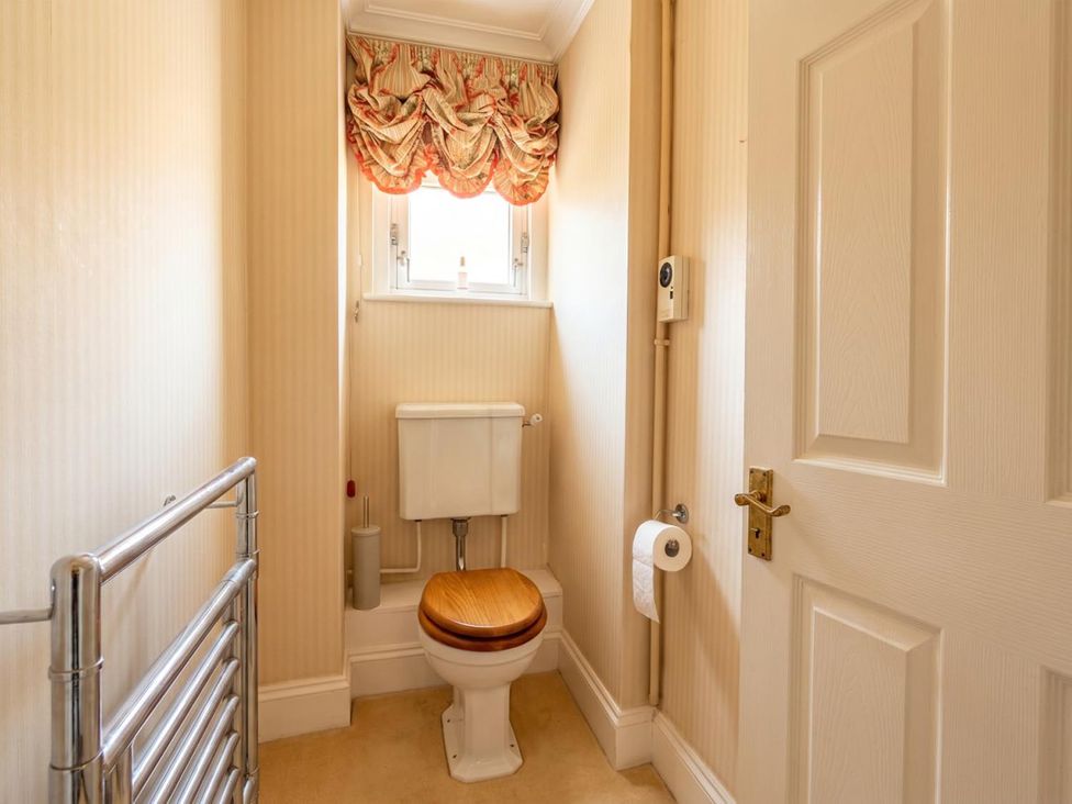 A bathroom with a toilet and towel rack at Circus Mews Townhouse 
