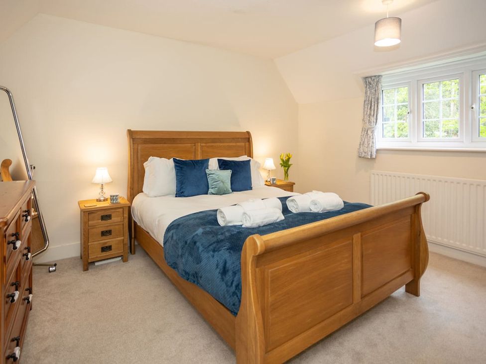 A bedroom with a bed and bedside table at the property
